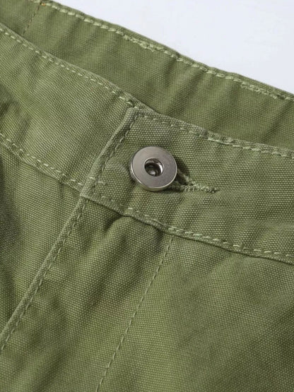 Men's distressed cargo pants with paint splatter from Trendsi, featuring rugged design and multiple pockets.