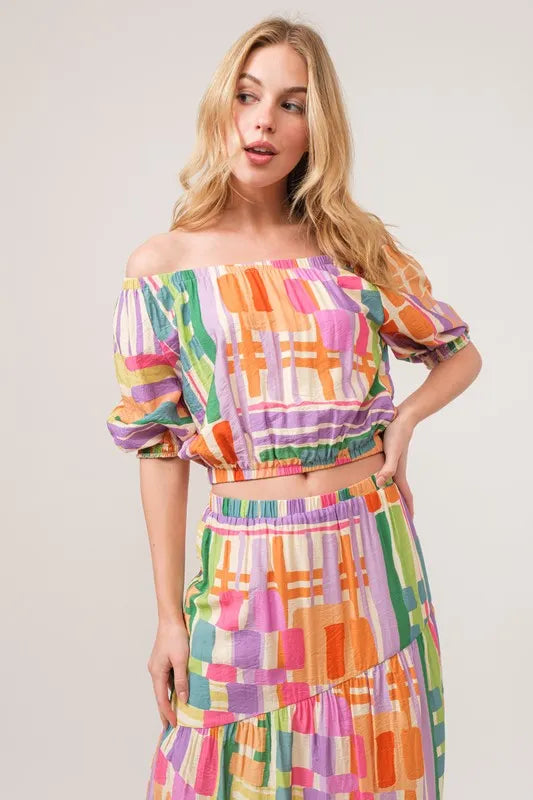 Trendsi And The Why asymmetric geo printed tiered maxi skirt with colorful geometric pattern and flowing fabric.