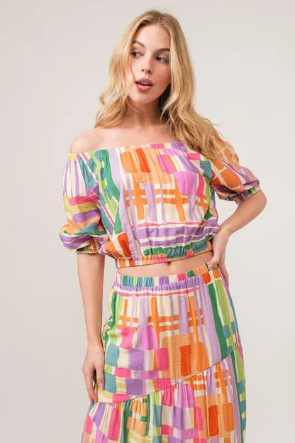 Trendsi And The Why asymmetric geo printed tiered maxi skirt with colorful geometric pattern and flowing fabric.