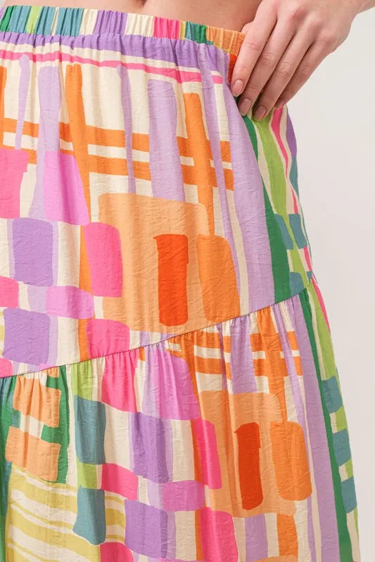 Trendsi asymmetric geo printed tiered maxi skirt with bold geometric patterns and flowing fabric, stylish and vibrant.