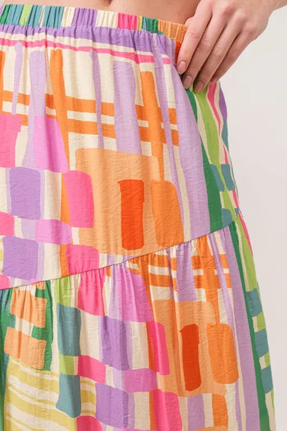 Trendsi asymmetric geo printed tiered maxi skirt with bold geometric patterns and flowing fabric, stylish and vibrant.