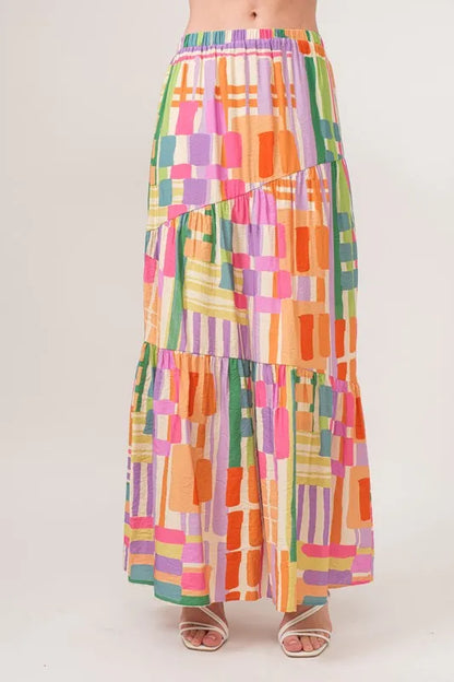 Trendsi asymmetric geo-printed tiered maxi skirt with vibrant patterns and flowing fabric, perfect for casual or stylish looks.