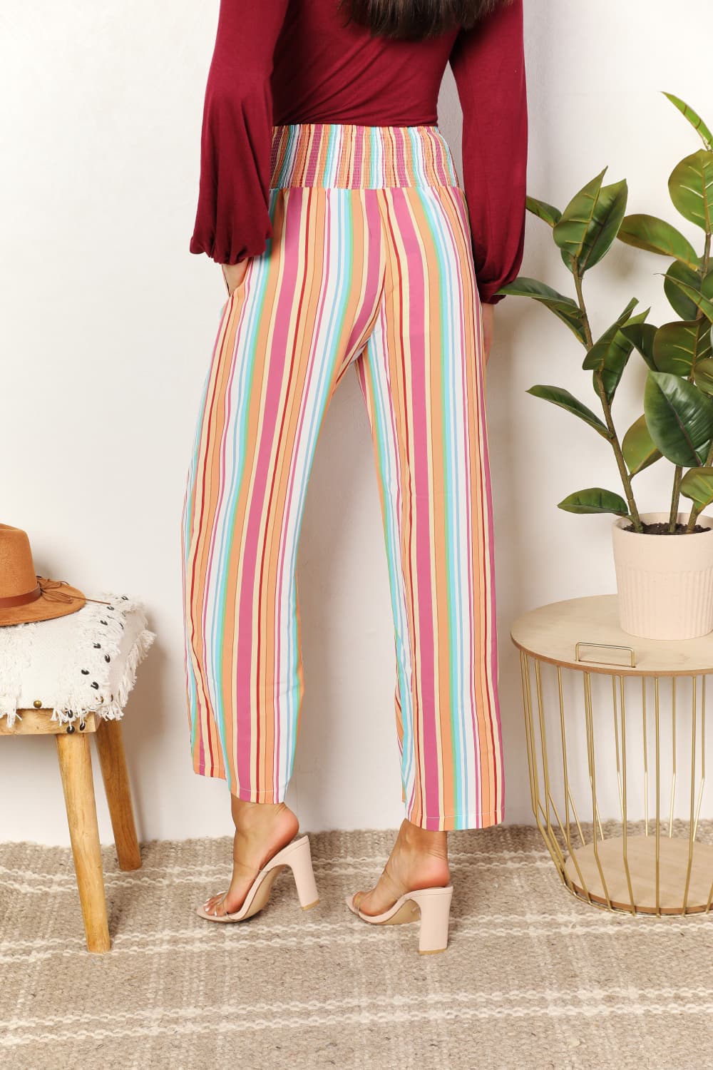 Multicolor striped smocked waist pants with pockets from Trendsi, featuring a relaxed fit and casual style.
