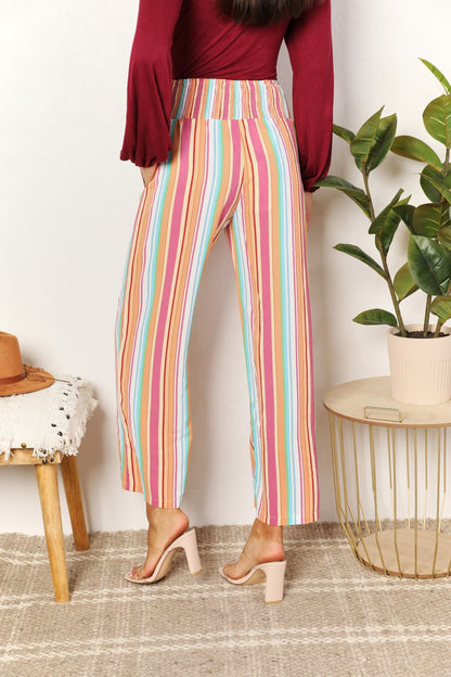 Multicolor striped smocked waist pants with pockets from Trendsi, featuring a relaxed fit and casual style.