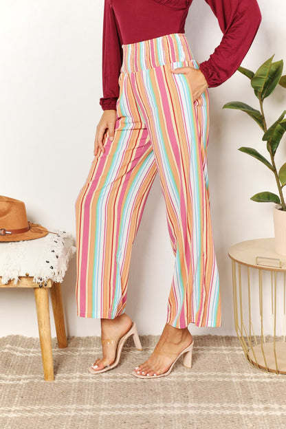 Multicolor double take striped smocked waist pants with pockets, by Trendsi, featuring a relaxed fit and vibrant pattern.