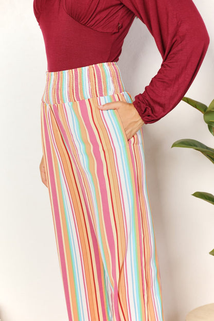 Multicolor striped smocked waist pants with pockets by Trendsi, featuring a relaxed fit and casual style.