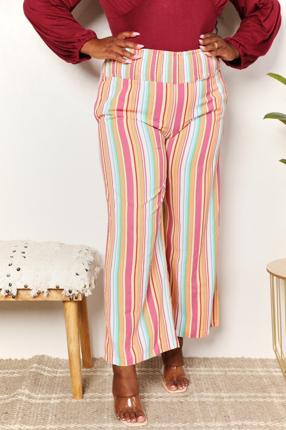 Multicolor striped smocked waist pants with pockets by Trendsi, casual and comfortable with a relaxed fit.