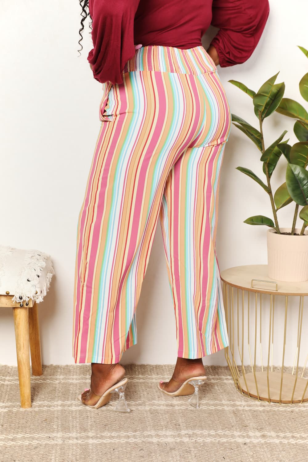Multicolor striped smocked waist pants with pockets from Trendsi, featuring a relaxed fit and comfortable style.