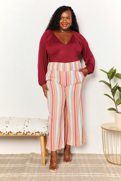 Multicolor striped smocked waist pants with pockets from Trendsi, featuring a relaxed fit and stylish design.