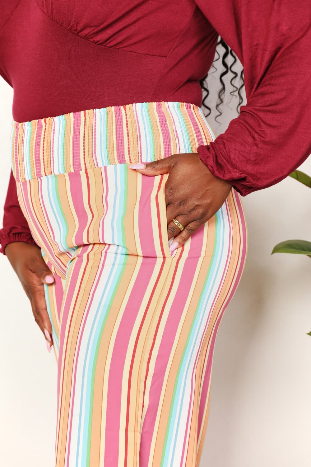 Multicolor striped smocked waist pants with pockets by Trendsi, featuring a relaxed fit and comfortable design.