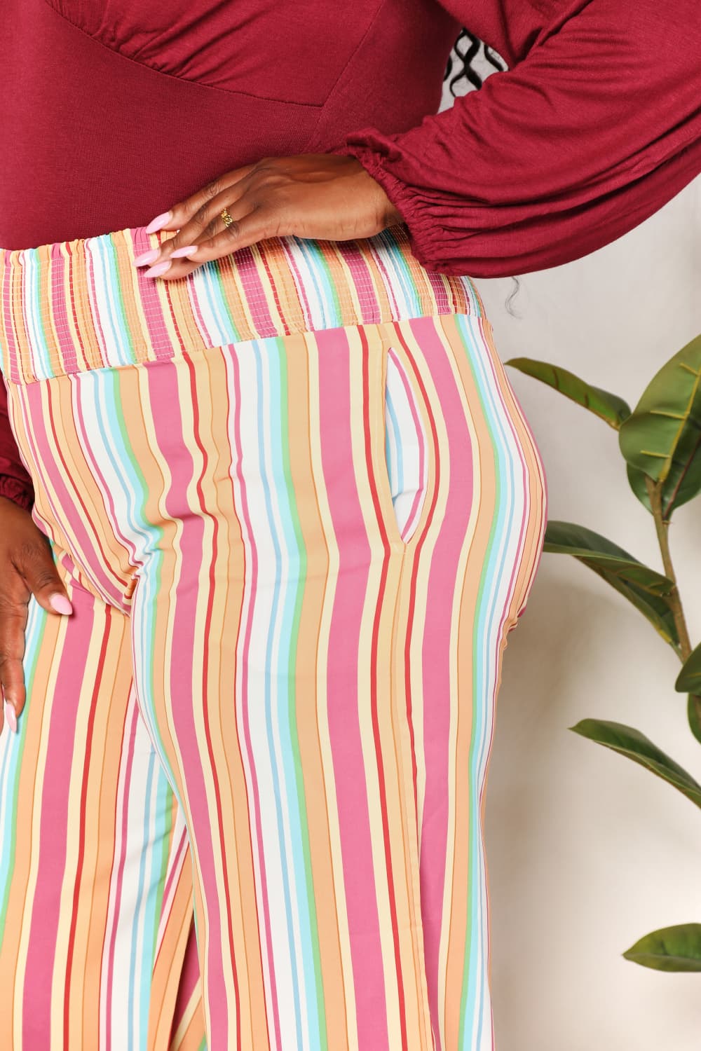Multicolor double take striped smocked waist pants with pockets by Trendsi, featuring a relaxed fit and vibrant pattern.