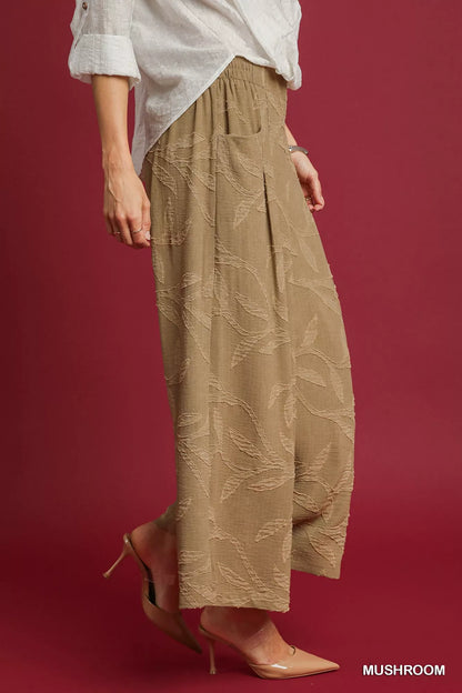 Umgee jacquard wide-leg pants in mushroom color with a relaxed fit and intricate woven pattern, displayed on a model.