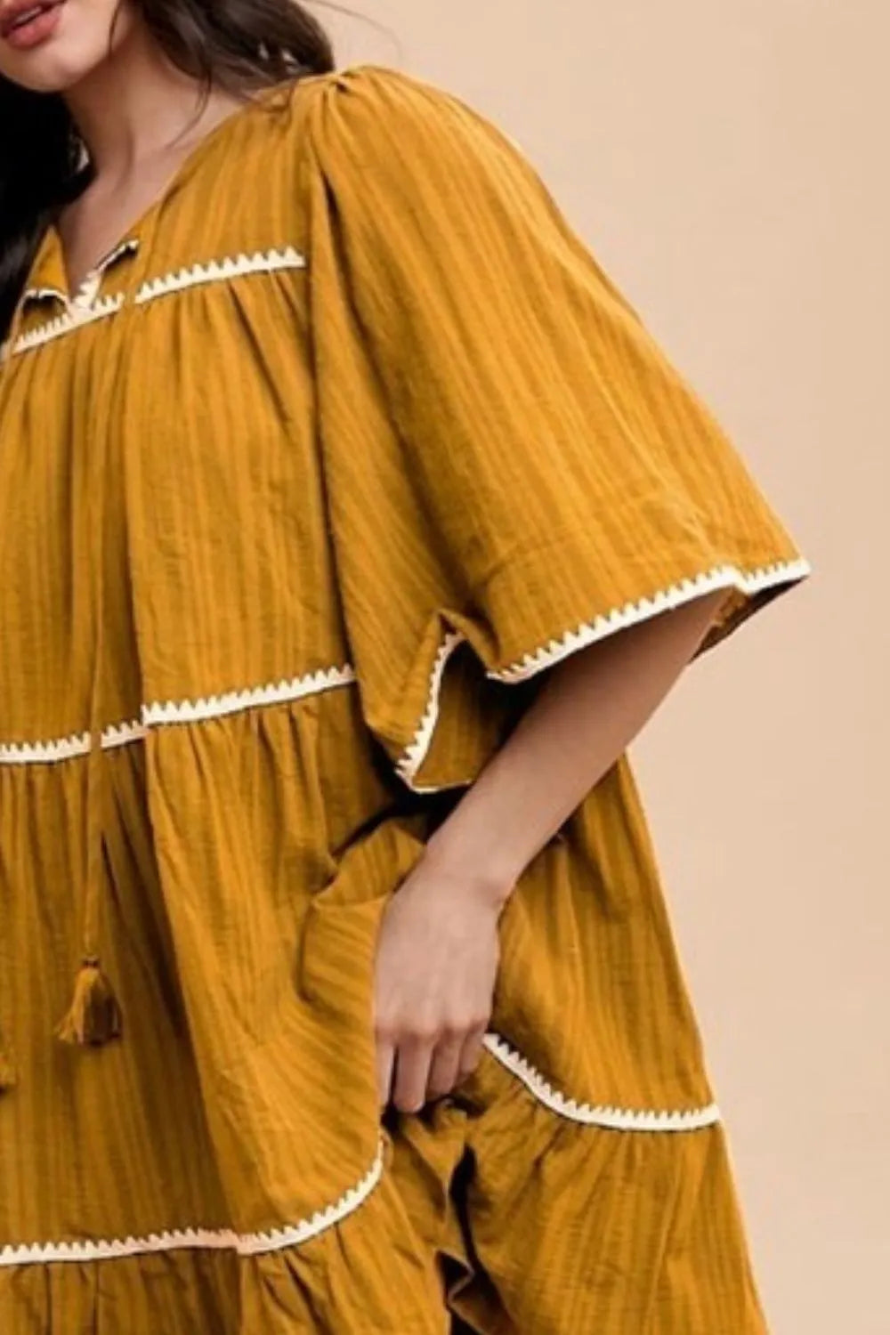 Mustard Annie Wear tassel contrast trim tie-neck half sleeve tiered dress, stylish and elegant for casual or dressy occasions.