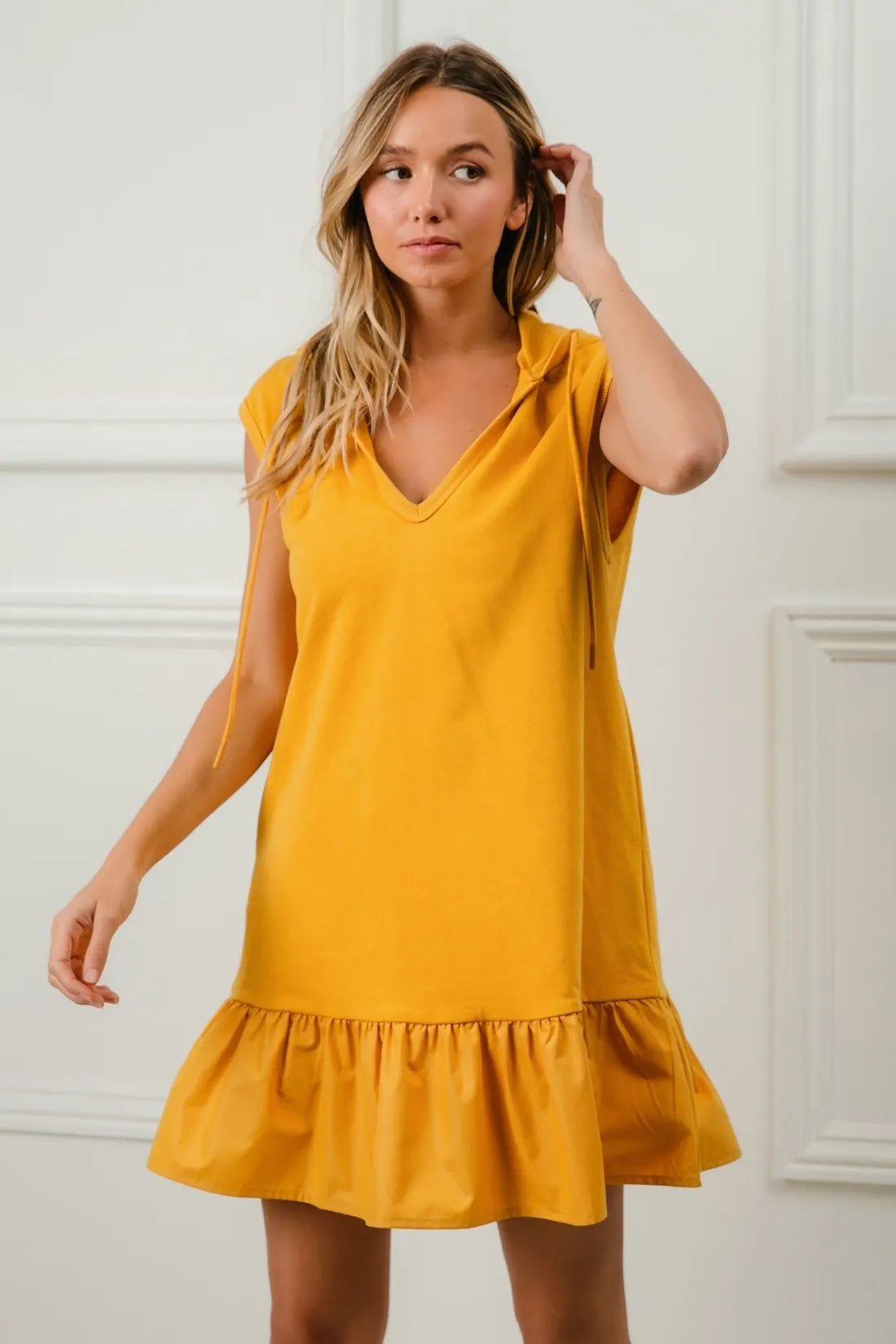 Mustard BiBi ruffled French Terry hooded dress by Trendsi, featuring a cozy hood and stylish ruffle details for casual wear.