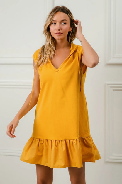 Mustard BiBi ruffled French Terry hooded dress by Trendsi, featuring a cozy hood and stylish ruffle details for casual wear.