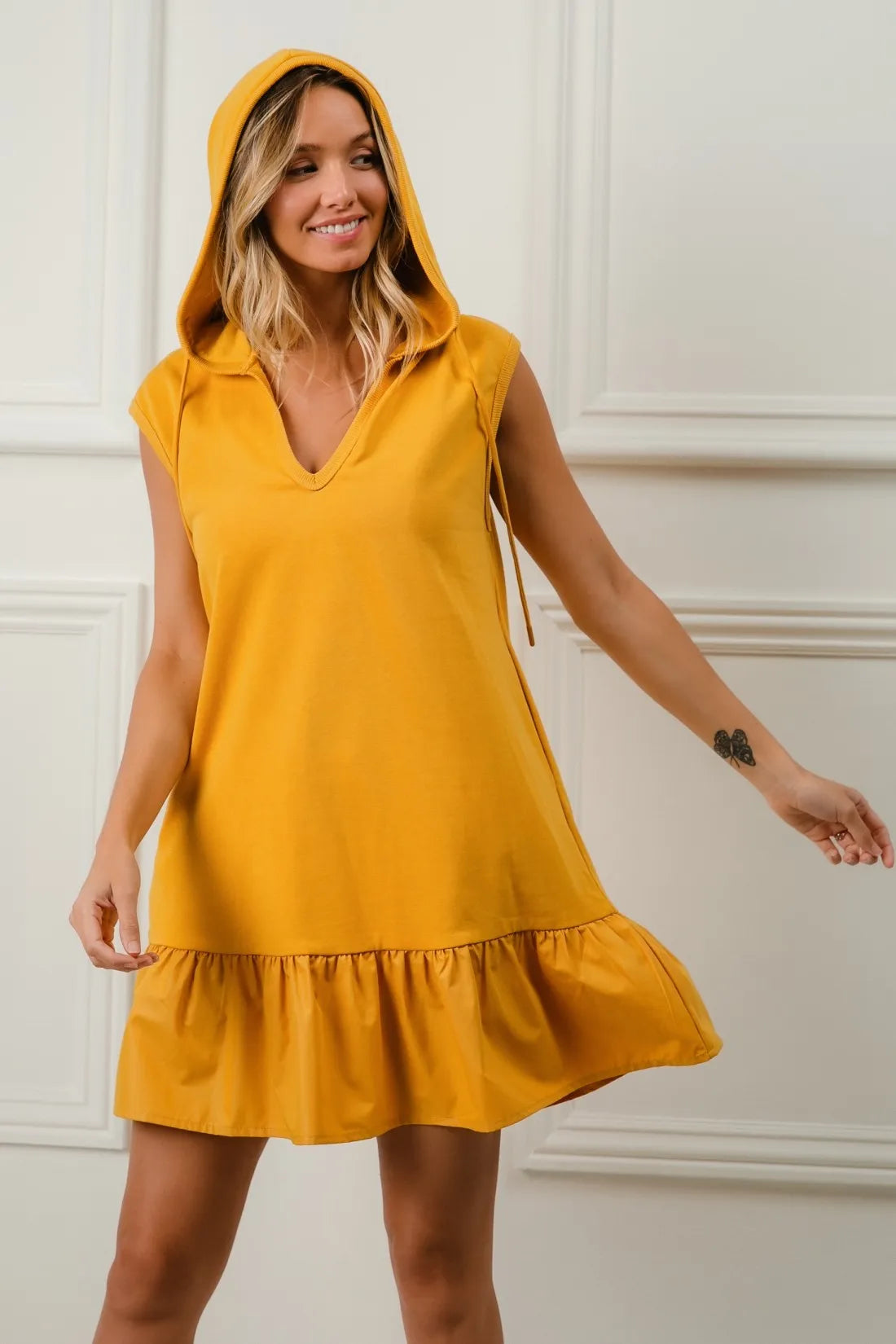 Mustard BiBi Ruffled French Terry Hooded Dress by Trendsi featuring ruffled details and a cozy hooded design.