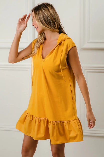 Mustard BiBi ruffled French Terry hooded dress by Trendsi, featuring a cozy hood and ruffled details for a stylish look.
