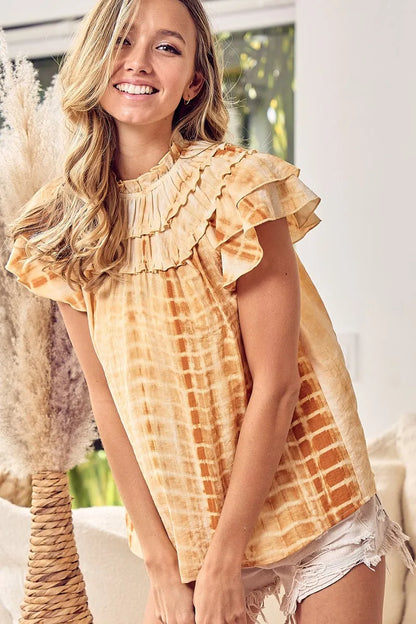 Mustard BiBi tiered ruffle neck tie-dye top from Trendsi, featuring a stylish layered design and vibrant tie-dye pattern.