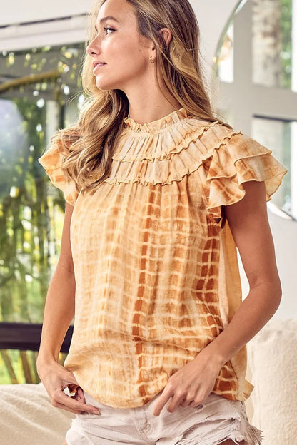 Mustard tie-dye BiBi tiered ruffle neck top by Trendsi featuring a flowy, layered design and ruffled neckline.
