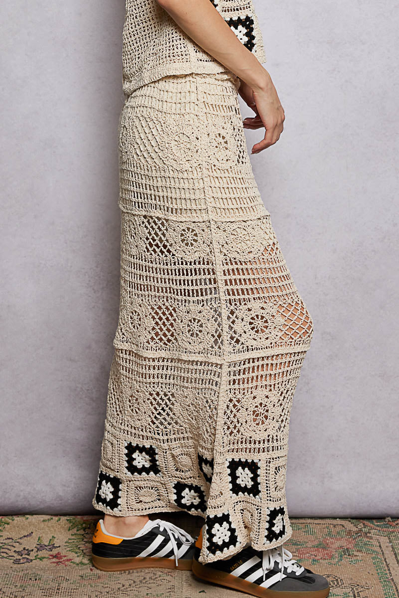 Natural black floral crochet maxi skirt with ruffled waistband and granny square weave by Trendsi, featuring a flowy, bohemian style.
