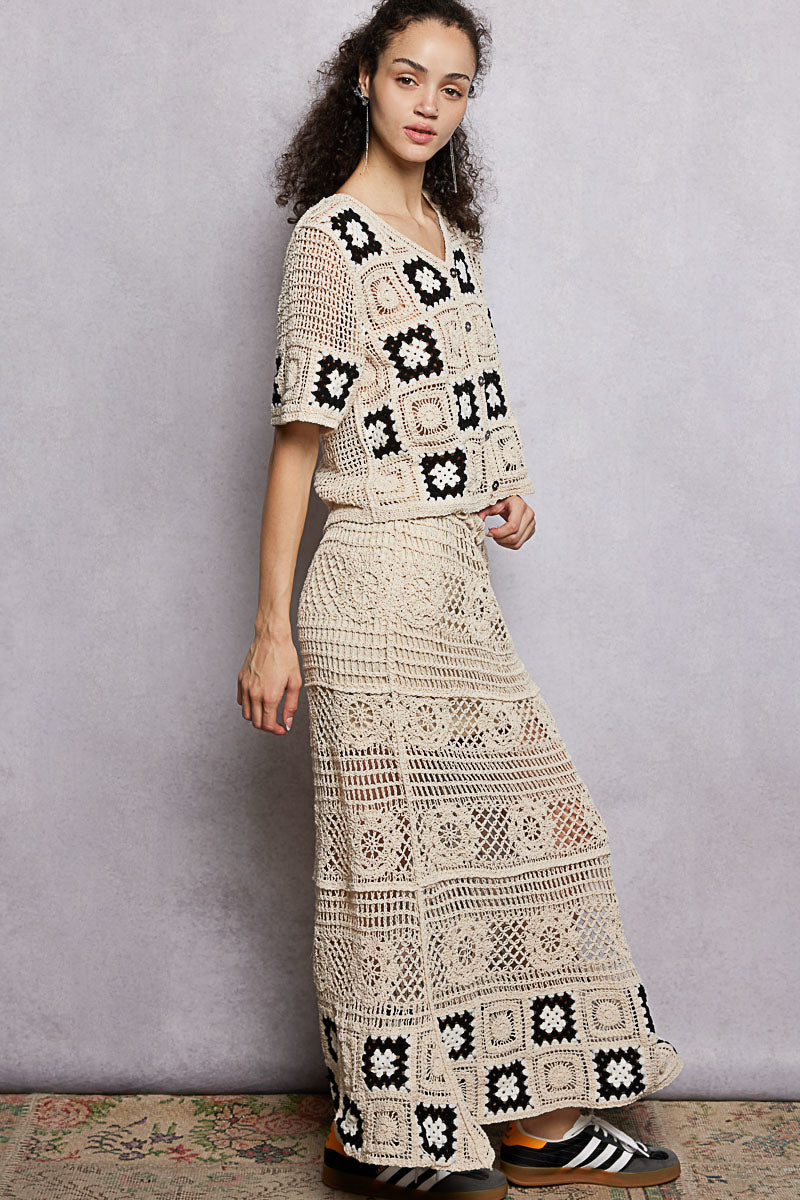 Natural black floral crochet maxi skirt with ruffled waistband and granny square weave, by Trendsi.