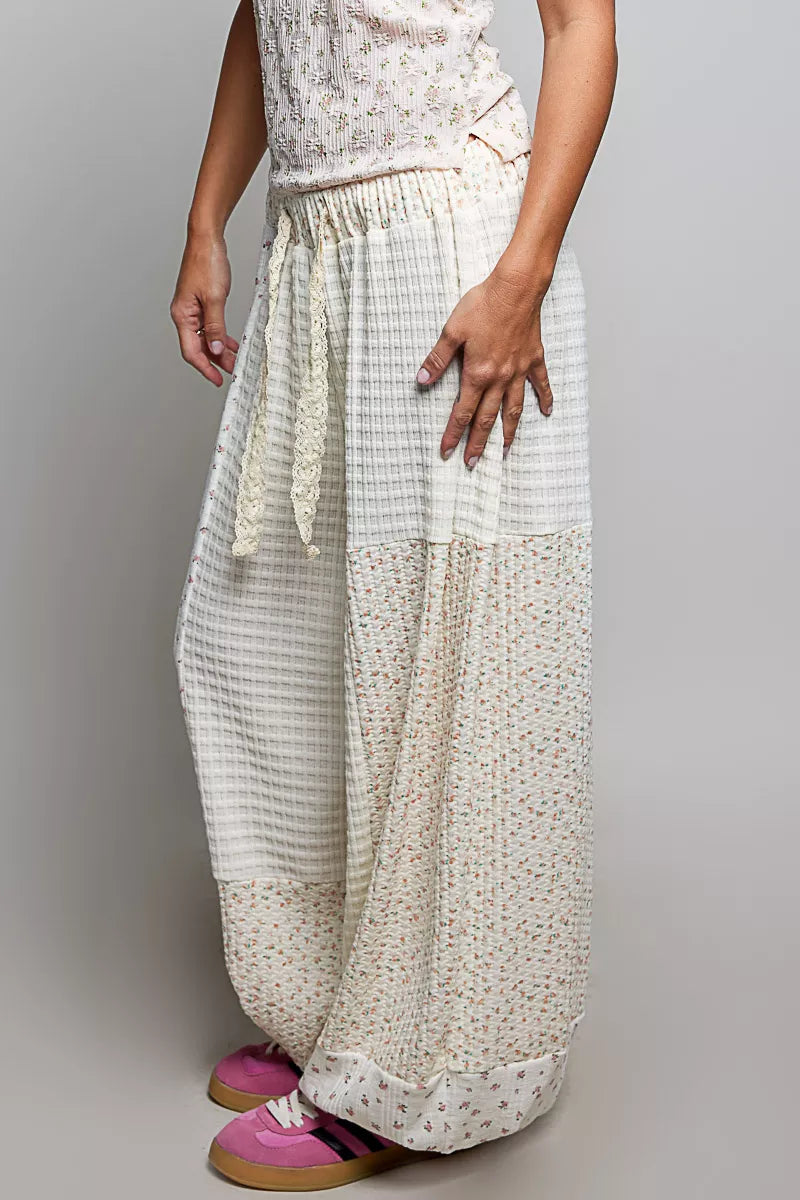 Natural multi-colored patchwork knit wide-leg pants from Trendsi, showcasing their relaxed fit and mixed fabric texture.