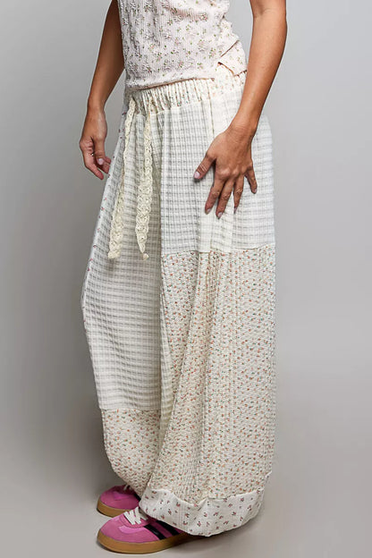 Natural multi-colored patchwork knit wide-leg pants from Trendsi, showcasing their relaxed fit and mixed fabric texture.