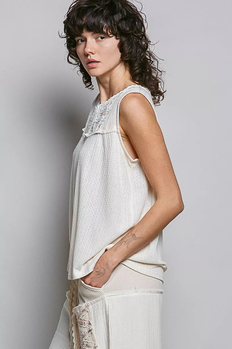Natural floral double gauze sleeveless top with lace detail by Trendsi, showcasing lightweight fabric and stylish patch accents.