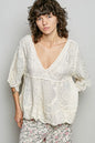 Natural V-neck crochet blouse by Trendsi with scalloped hem, shown in a neutral color, detailed knit fabric and feminine style.