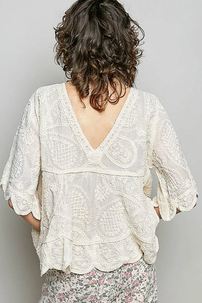 Natural V-neck crochet blouse with scalloped hem by Trendsi, featuring intricate crochet pattern and feminine design.