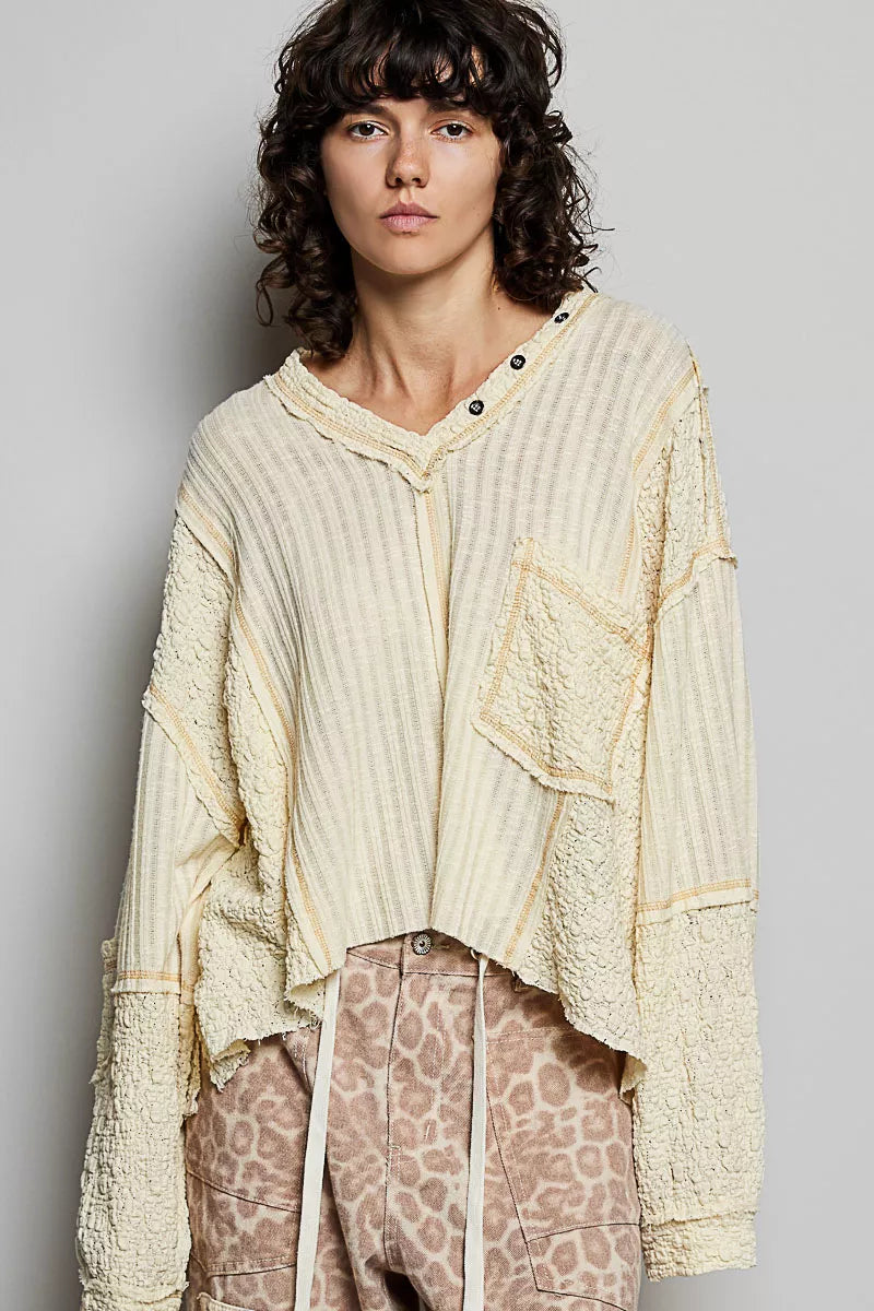 Natural V-neck long sleeve top with stitch detail by Trendsi, shown in a neutral color, featuring a fitted silhouette and subtle stitching accents.