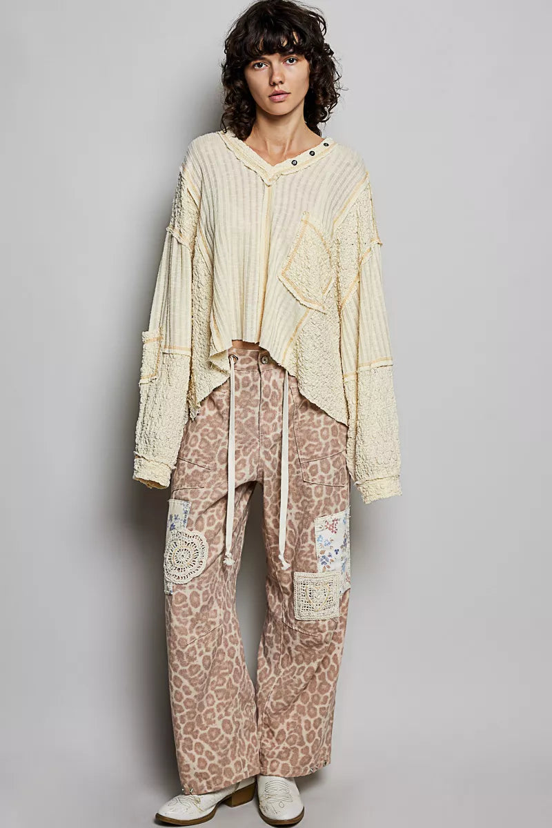 Natural V-neck long sleeve top with stitch detail from Trendsi, showcasing soft fabric and stylish design.