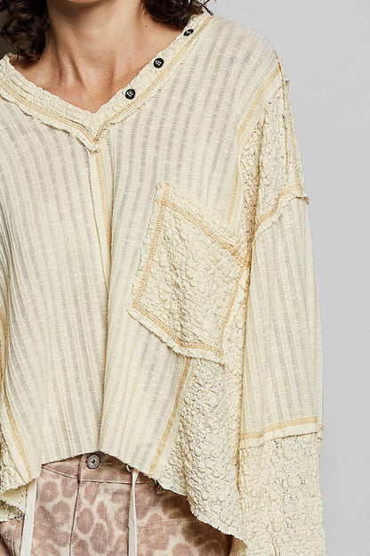 Natural V-neck long sleeve top with stitch detail from Trendsi, featuring a fitted design and subtle seam accents.