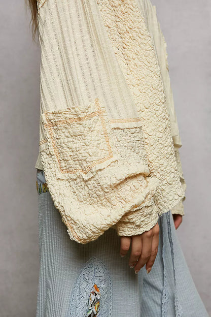 Natural V-neck long sleeve top with stitch detail by Trendsi, featuring a comfortable fit and subtle textured accents.