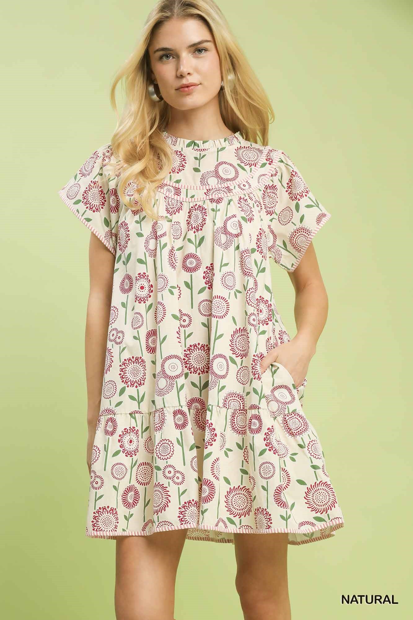 Natural beige Umgee floral print tiered babydoll dress with ruffled neckline and flowy silhouette, perfect for casual and summer wear.