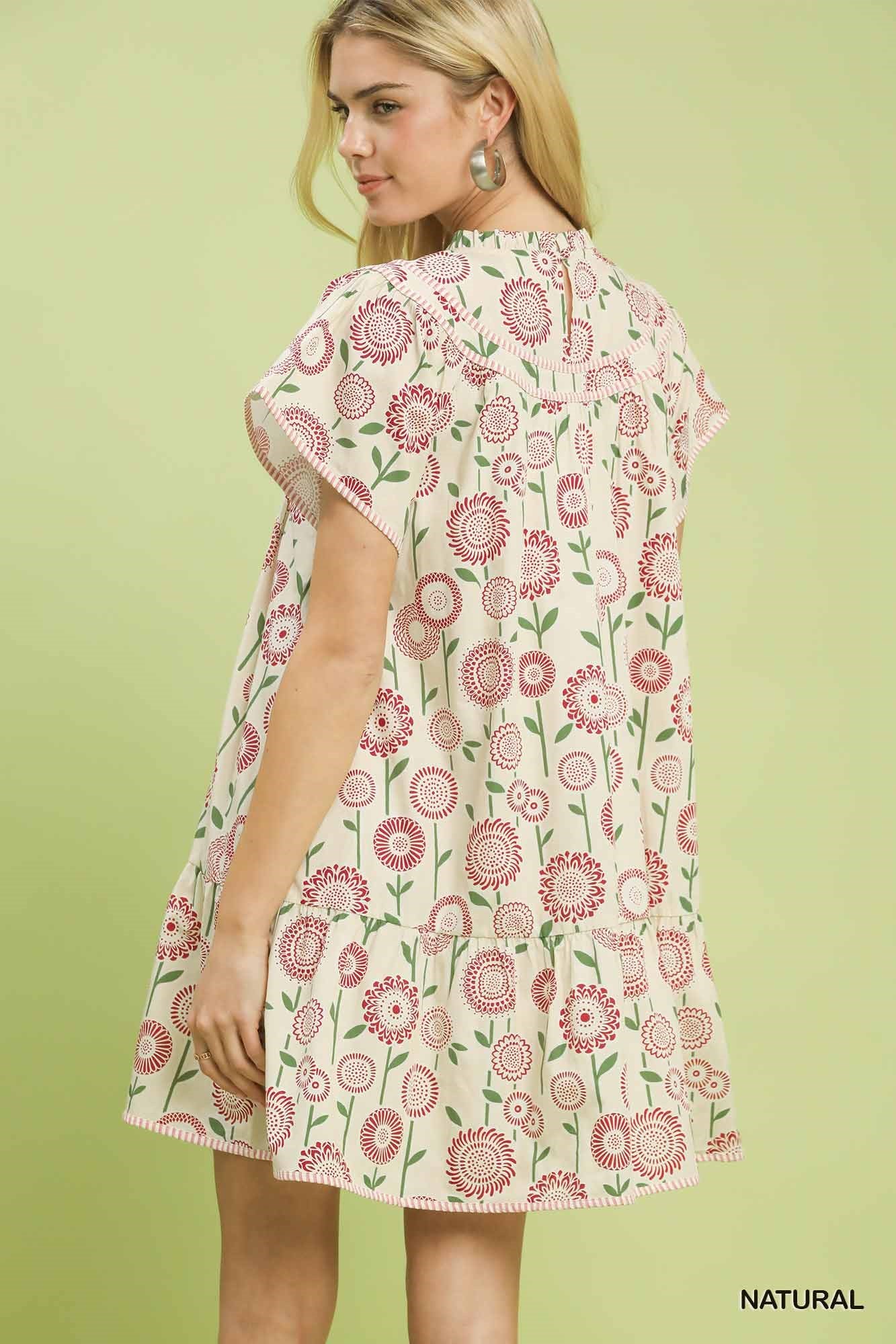 Natural beige floral print tiered babydoll dress by Umgee with ruffled sleeves and flowy silhouette.