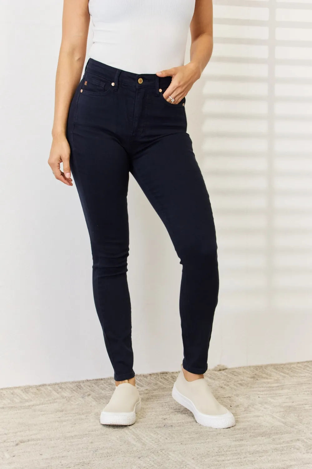 Navy Judy Blue full-size garment dyed tummy control skinny jeans, shown on a model, featuring a sleek, fitted silhouette.
