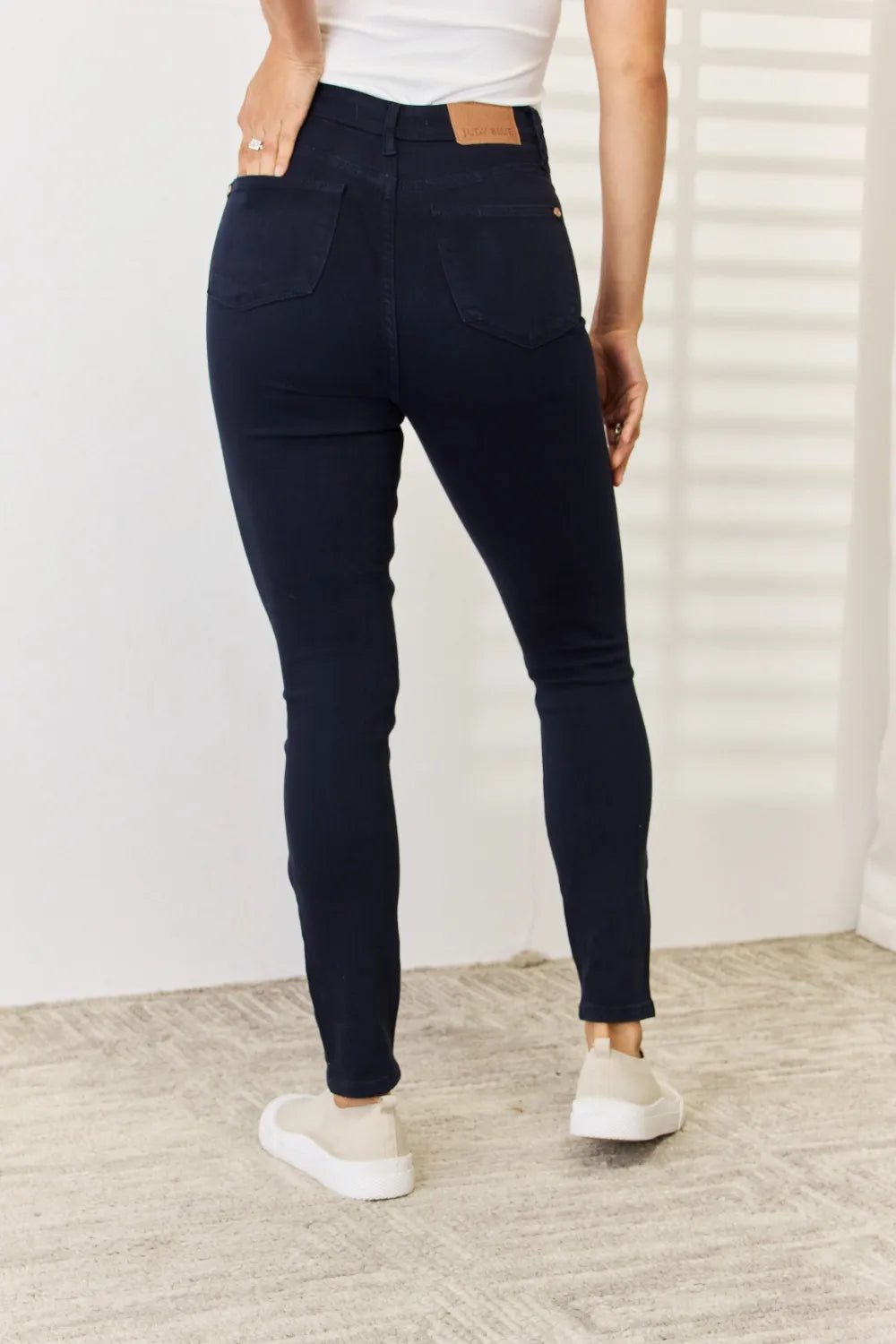 Navy Judy Blue full-size garment-dyed tummy control skinny jeans, shown on a model with a close-up of the fabric and fit.