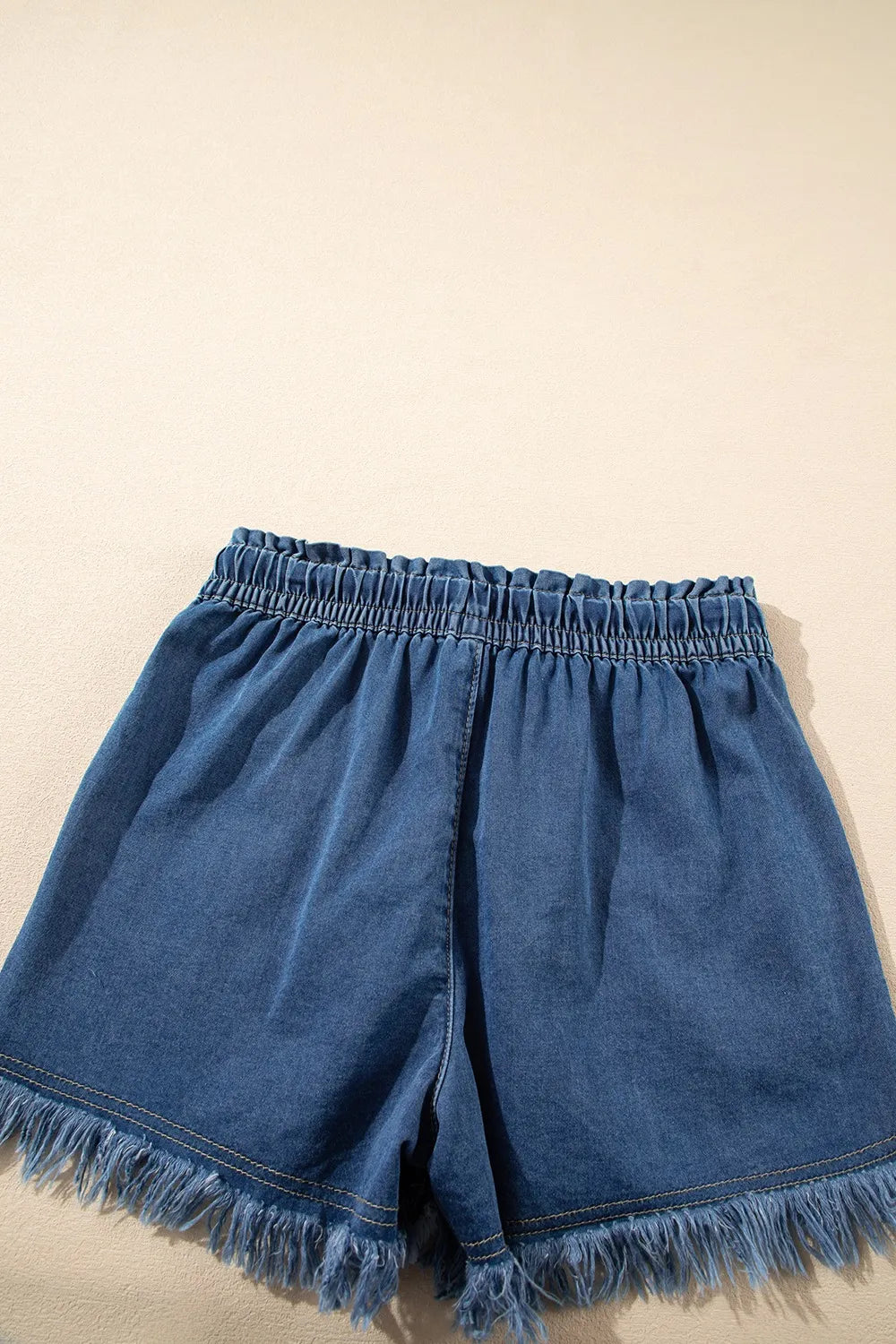 Navy raw hem drawstring high waist denim shorts with front pockets, stylish and casual by Trendsi.