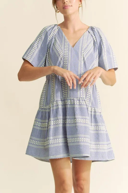 Navy blue Davi & Dani embroidered stripe ruffled gingham mini dress with short sleeves and a fitted waist, styled for casual wear.