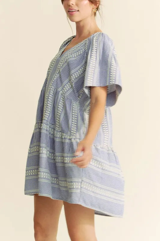 Navy blue Davi & Dani embroidered stripe ruffled gingham mini dress, featuring a fitted bodice with ruffles and short sleeves.