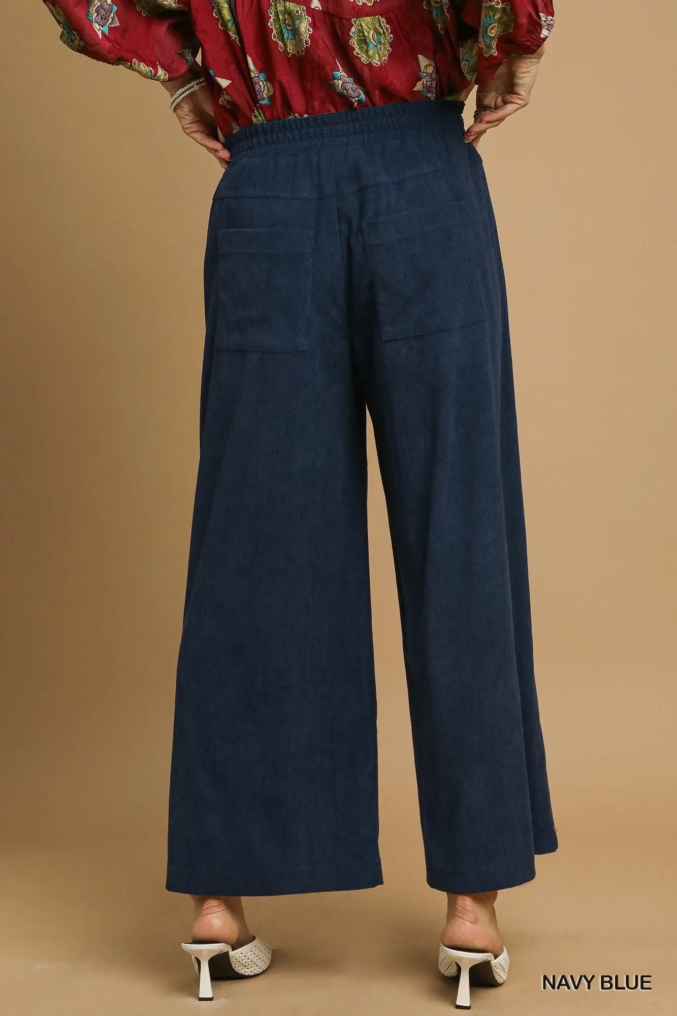 Navy blue Umgee wide-leg corduroy pants with high waist and relaxed fit, styled for casual wear.