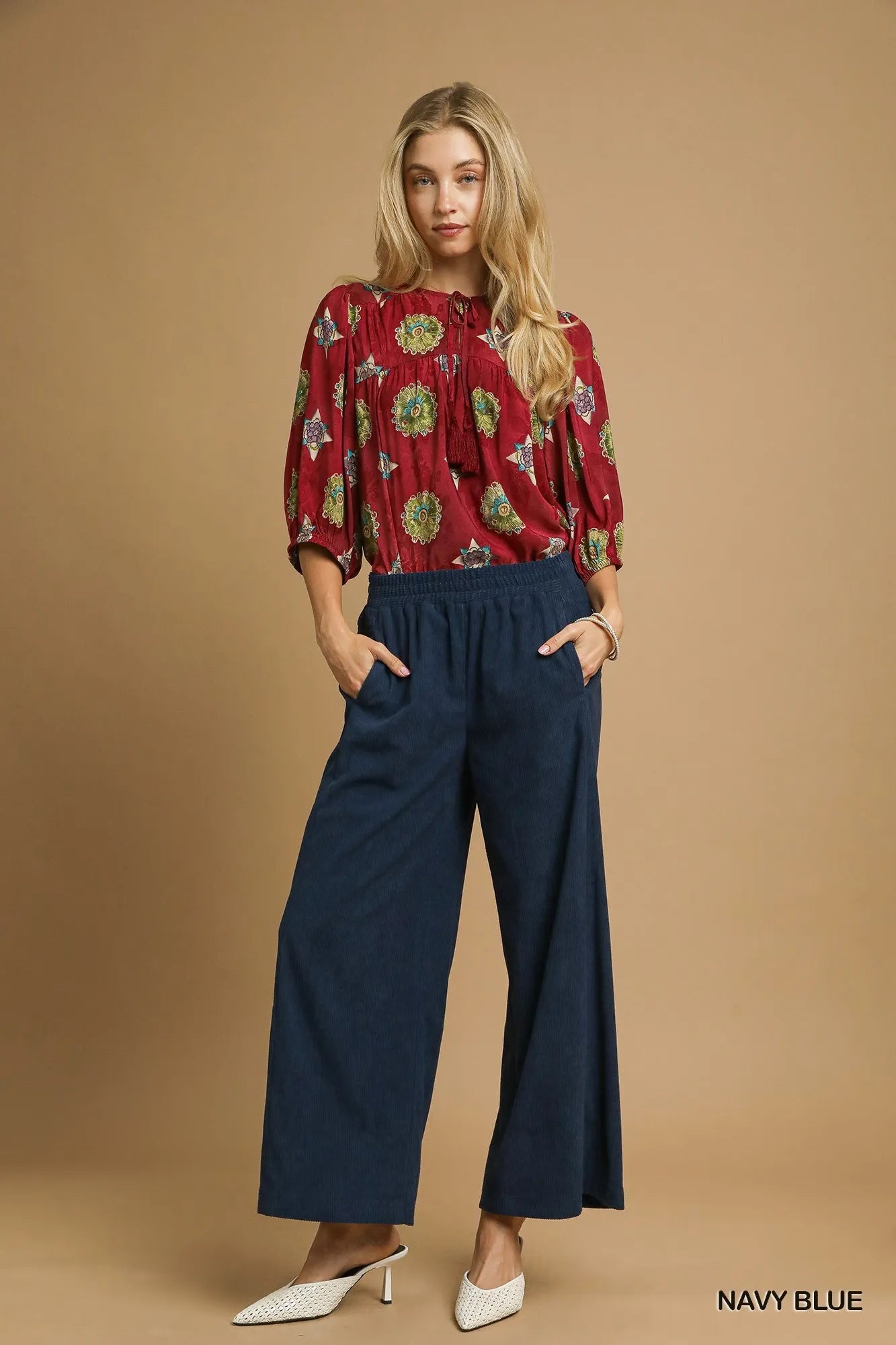 Navy blue Umgee wide-leg corduroy pants with high waist and relaxed fit, shown on a model.