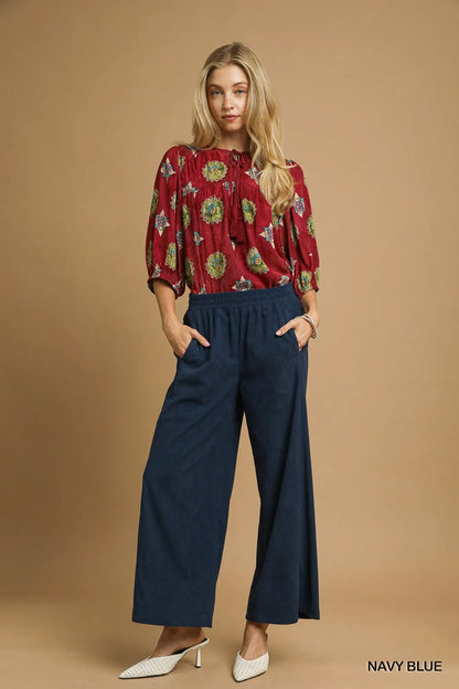 Navy blue Umgee wide-leg corduroy pants with high waist and relaxed fit, shown on a model.