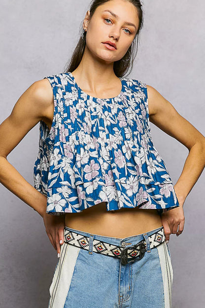 Navy floral round neck cropped tank top with pintuck details from Trendsi, featuring a relaxed fit and feminine floral pattern.