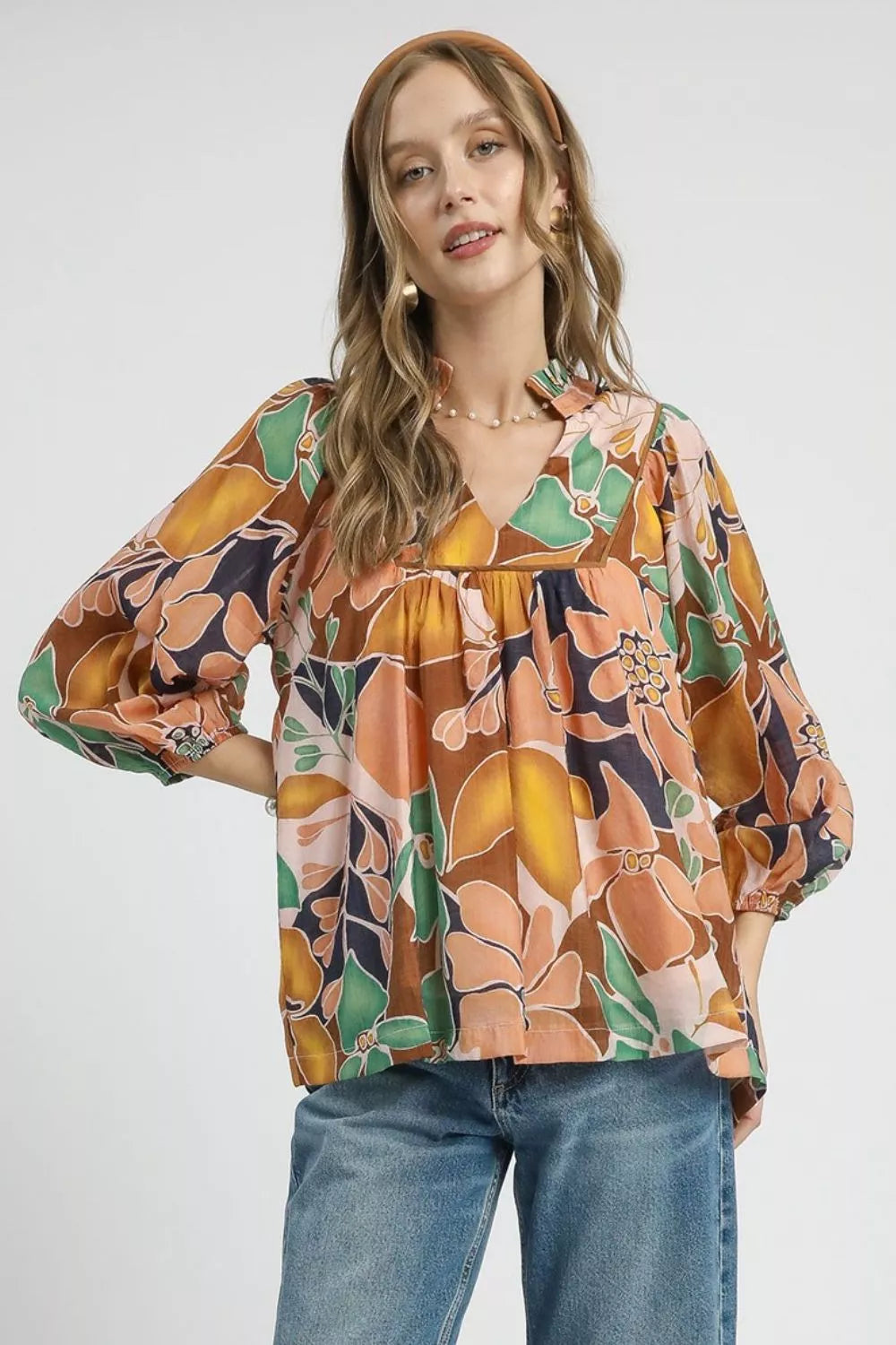 Trendsi Umgee multicolor floral print blouse with ruffle neckline and long sleeves, abstract floral design in navy and bright colors.