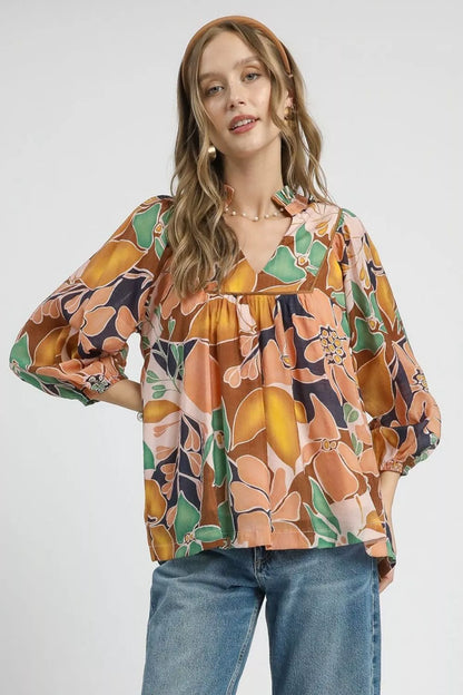Trendsi Umgee multicolor floral print blouse with ruffle neckline and long sleeves, abstract floral design in navy and bright colors.