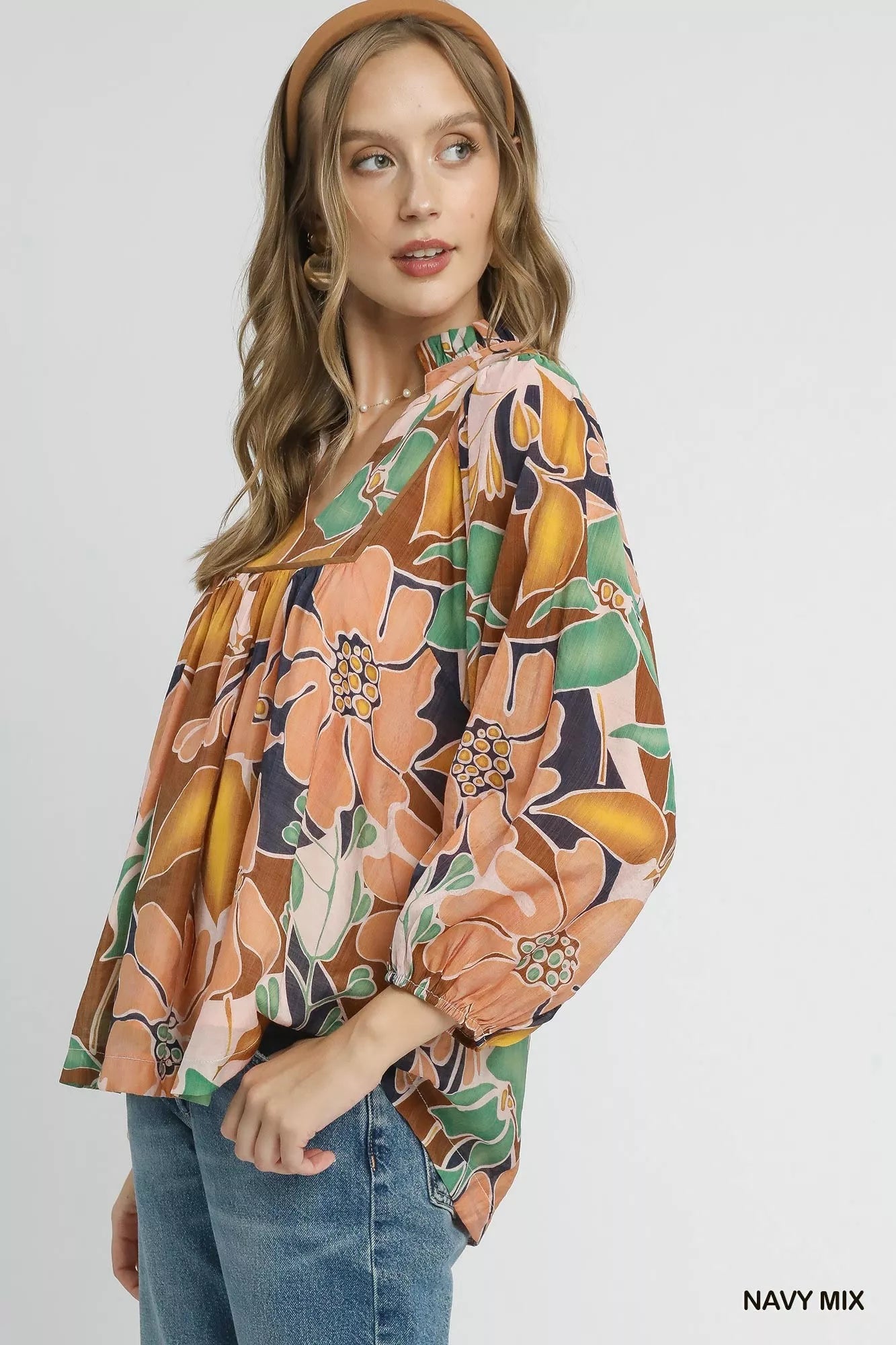 Multicolor abstract floral print blouse by Umgee with ruffle neck, featuring a stylish and vibrant design.