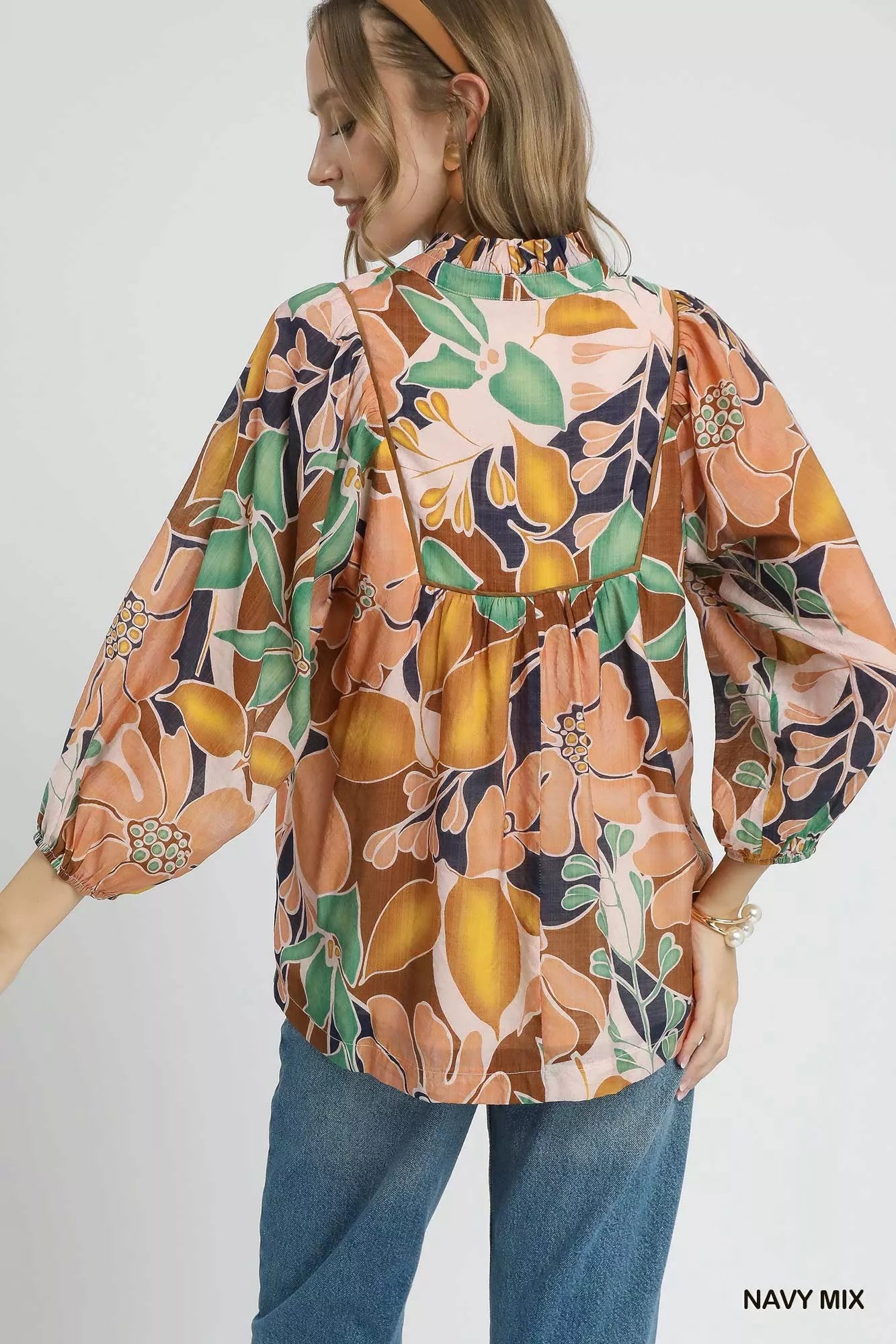 Multicolor abstract floral print blouse by Umgee with ruffle neckline, featuring a stylish and vibrant design.