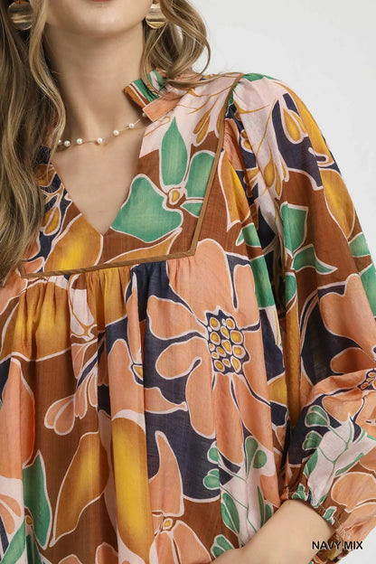 Multicolor abstract floral print blouse with ruffle neck by Umgee, featuring a stylish and vibrant design.